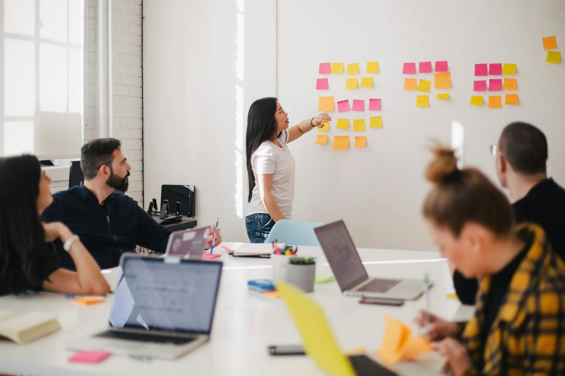 Team planning strategy with sticky notes on whiteboard